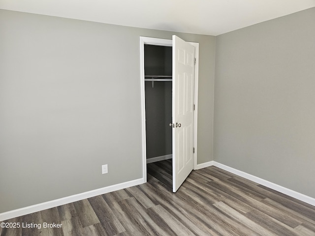 unfurnished bedroom featuring a closet and wood-type flooring