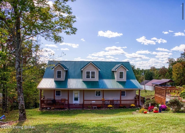 view of front of property with metal roof, a deck, and a front lawn