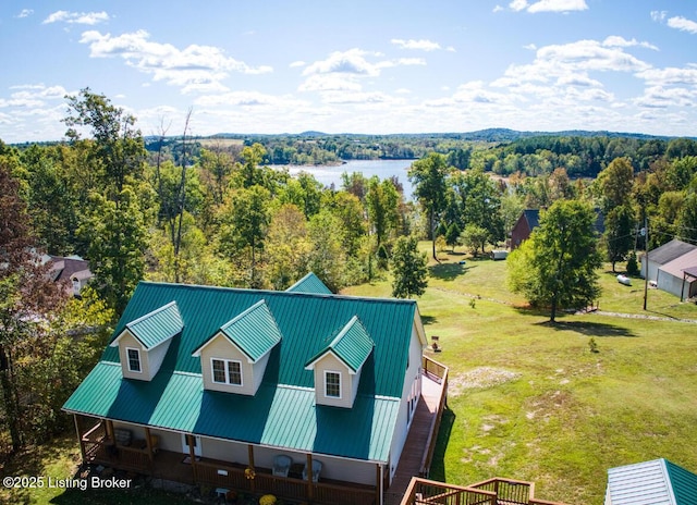 birds eye view of property with a water view and a view of trees