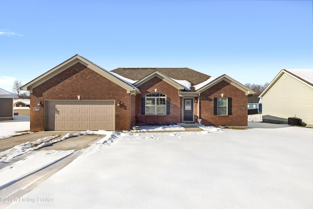 ranch-style house with a garage and central air condition unit