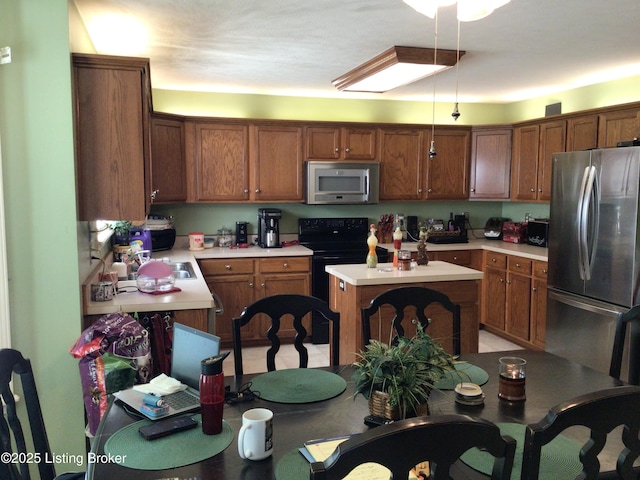 kitchen featuring sink, a center island, and stainless steel appliances