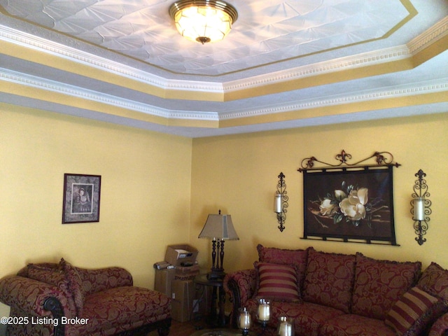 living room featuring crown molding and a tray ceiling