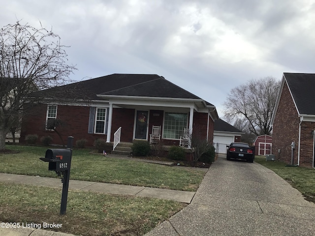 view of front of home featuring a porch, a garage, central AC unit, a front yard, and a shed