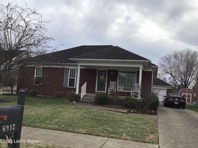 view of front facade with a garage, a front yard, and covered porch