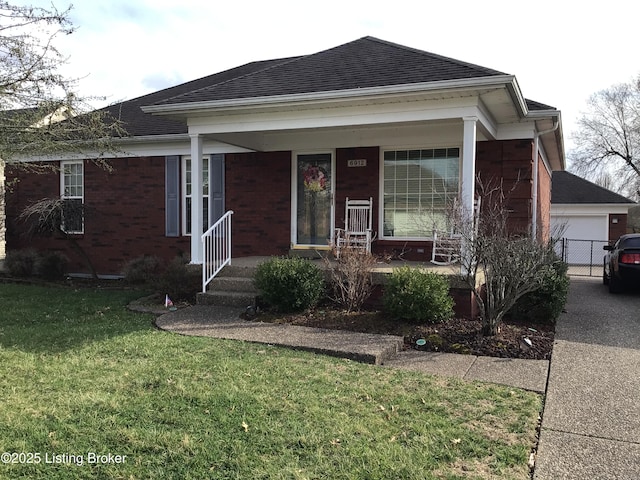 ranch-style home with roof with shingles, covered porch, a front lawn, a garage, and brick siding