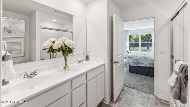 bathroom with an enclosed shower and vanity