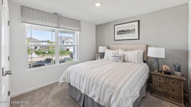 bedroom featuring light carpet