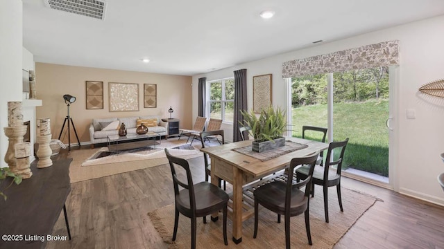 dining space with hardwood / wood-style floors