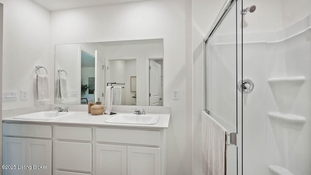 bathroom featuring an enclosed shower and vanity