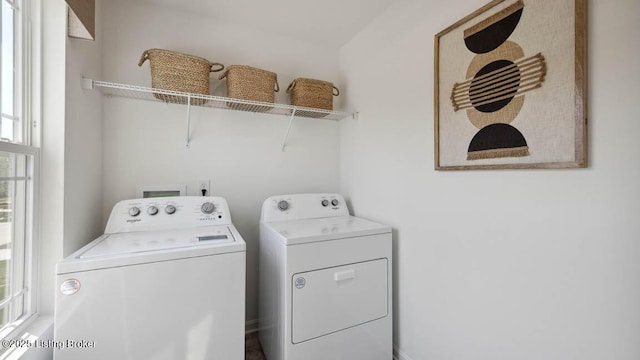 clothes washing area with washing machine and clothes dryer