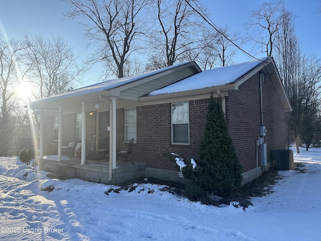 view of front of home with central AC and a porch