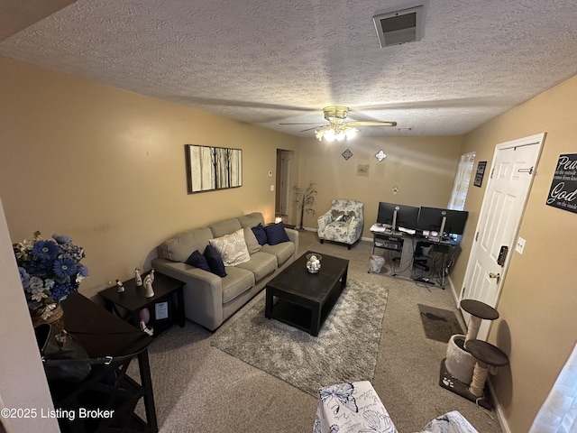 carpeted living room featuring a textured ceiling and ceiling fan