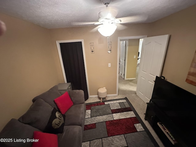 bedroom with a textured ceiling, ceiling fan, and connected bathroom