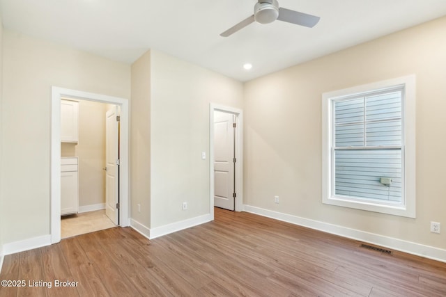 unfurnished bedroom featuring recessed lighting, visible vents, light wood-style flooring, and baseboards