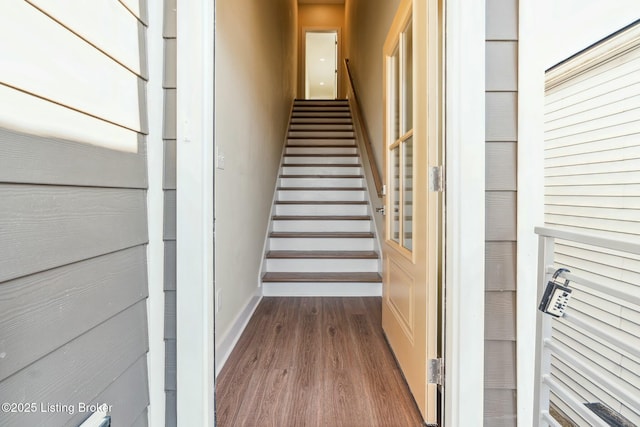 stairway featuring baseboards and wood finished floors