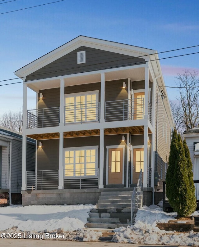 view of front of property with a porch and a balcony