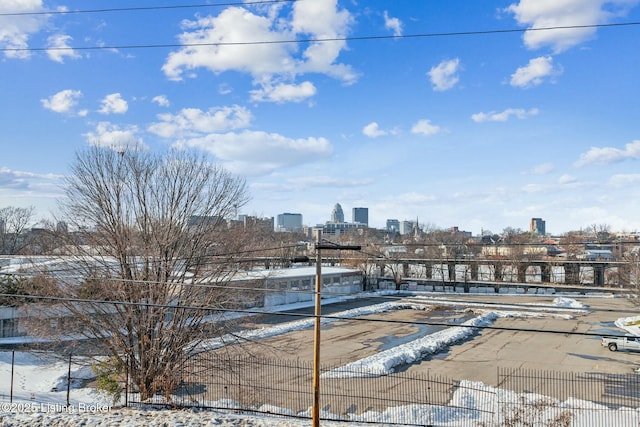 exterior space featuring a view of city and fence