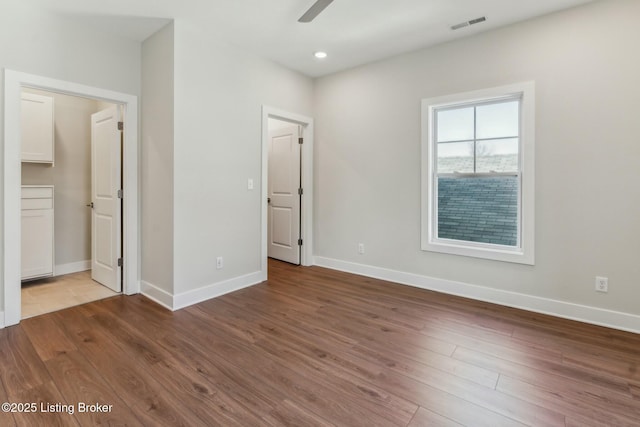 unfurnished bedroom featuring recessed lighting, visible vents, baseboards, and wood finished floors