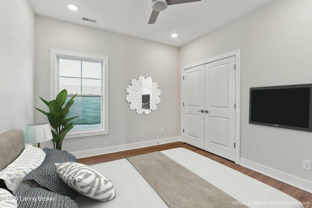 bedroom featuring wood finished floors, visible vents, and baseboards