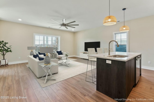 living room featuring recessed lighting, baseboards, light wood-type flooring, and ceiling fan