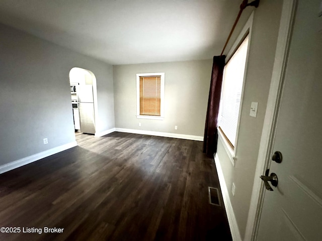 unfurnished room featuring dark hardwood / wood-style floors