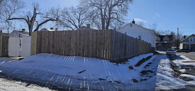 snowy yard with fence