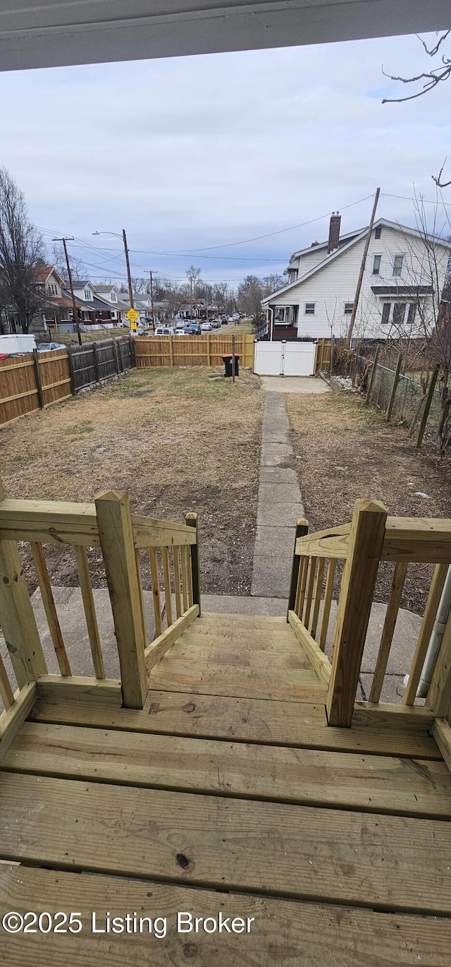 view of yard with a fenced backyard and a wooden deck