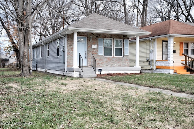 bungalow-style home featuring a front lawn