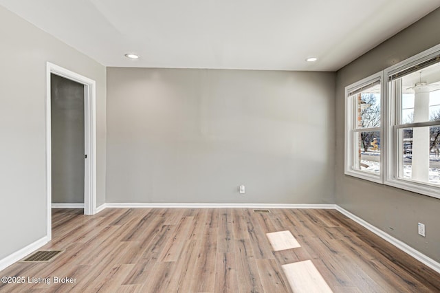 spare room with light hardwood / wood-style flooring