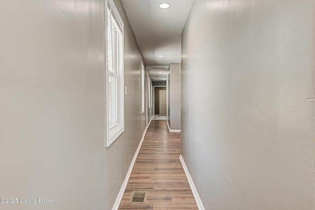 hallway with wood-type flooring