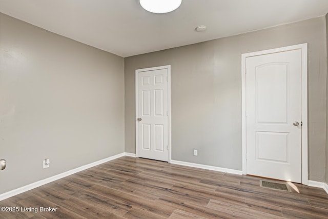 unfurnished room featuring dark hardwood / wood-style floors