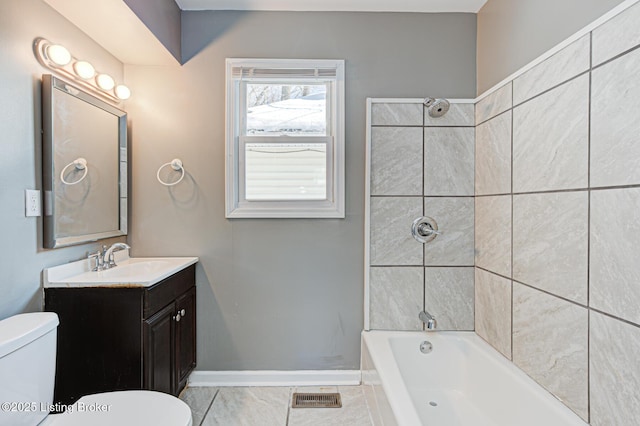 bathroom with a bathtub, vanity, and toilet