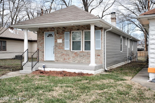 bungalow-style home featuring a porch and a front yard