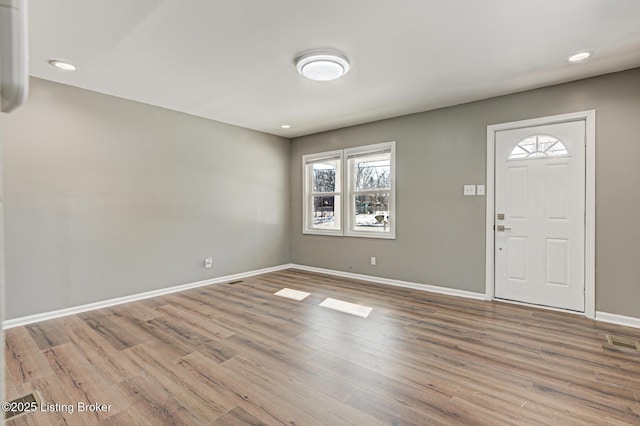 entryway with wood-type flooring and a healthy amount of sunlight