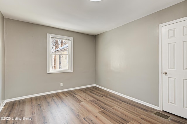 spare room with hardwood / wood-style floors