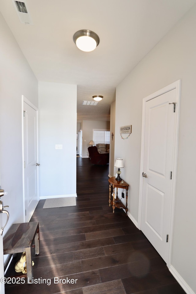 hall with dark wood-type flooring