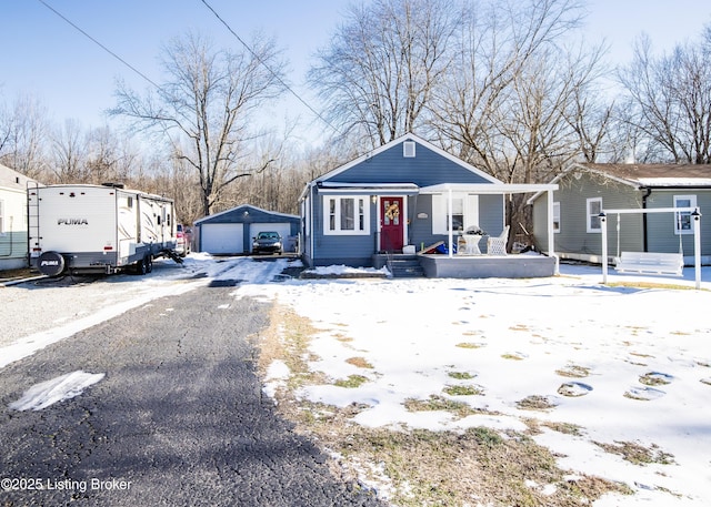 view of front of property with covered porch, an outdoor structure, and a garage