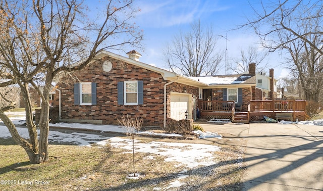 view of front of home featuring a garage and a wooden deck