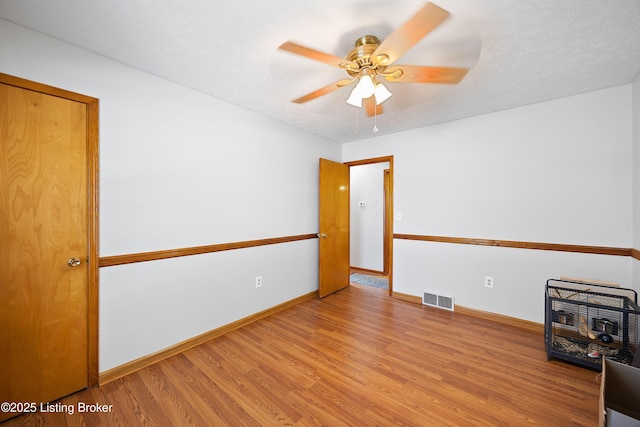 unfurnished room with ceiling fan and light hardwood / wood-style floors