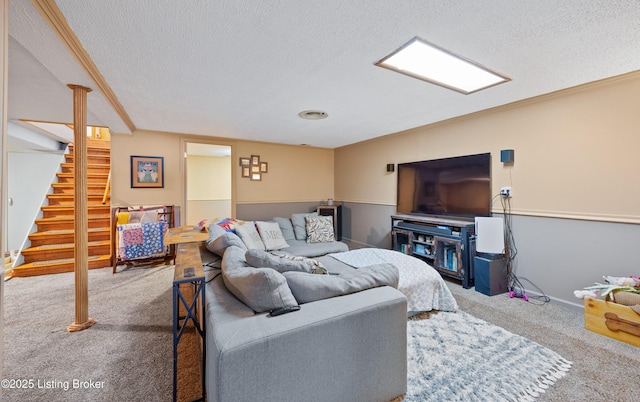 living room featuring carpet floors, a textured ceiling, and ornamental molding