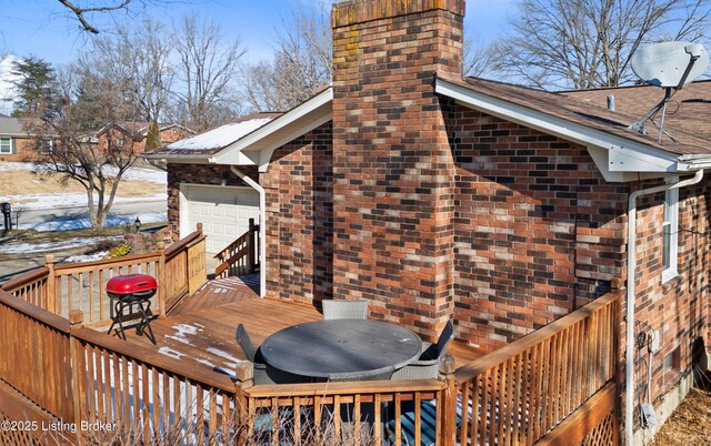 snow covered deck featuring grilling area