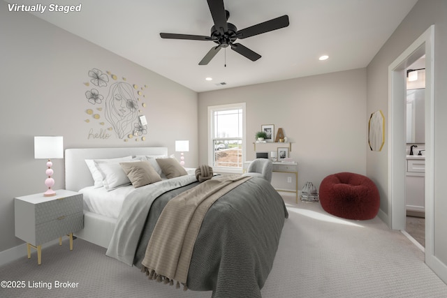 bedroom featuring carpet flooring, sink, and ceiling fan