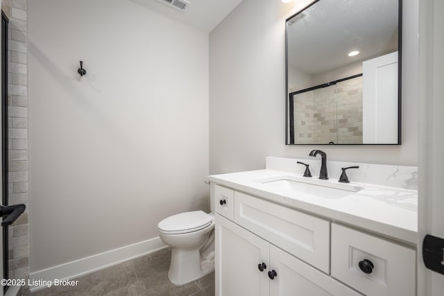 bathroom with walk in shower, vanity, and toilet