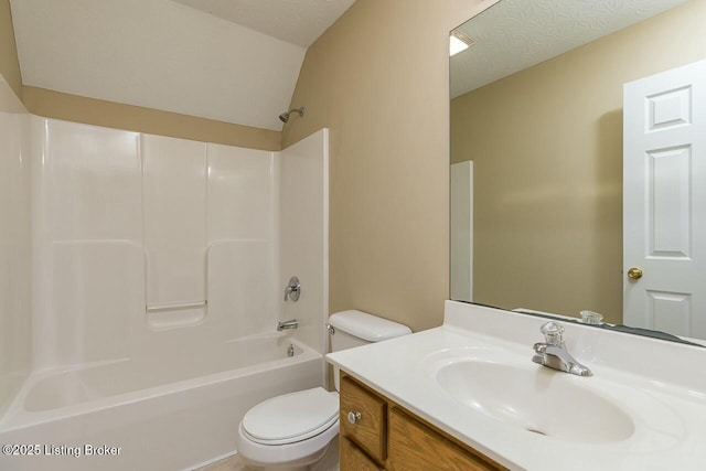 full bathroom featuring toilet, a textured ceiling, tub / shower combination, and vanity