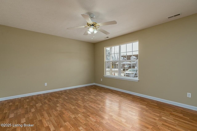 unfurnished room featuring a textured ceiling, ceiling fan, and wood-type flooring