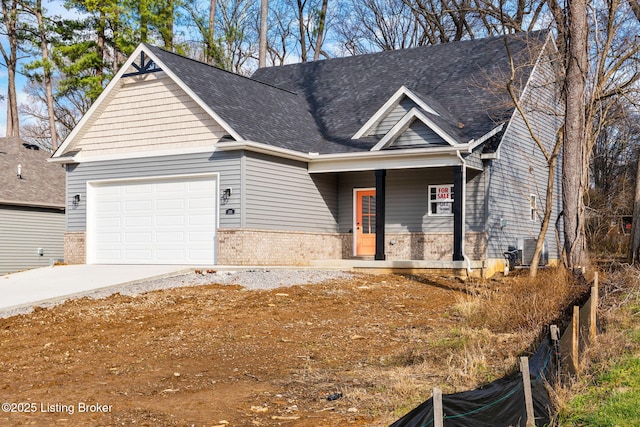 craftsman-style home featuring central AC unit, covered porch, and a garage