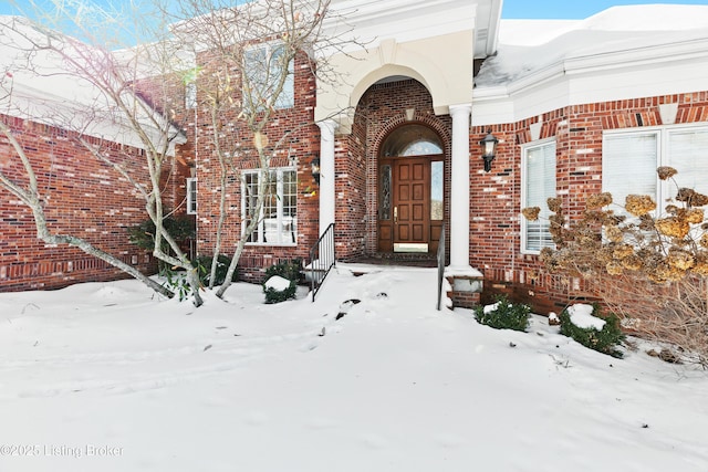 view of snow covered property entrance