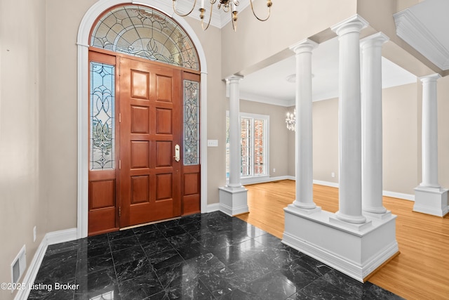 foyer entrance with crown molding and ornate columns