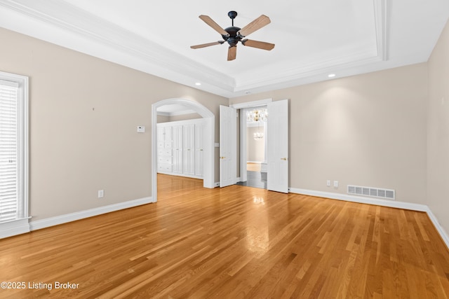 interior space featuring ceiling fan, hardwood / wood-style flooring, and a raised ceiling