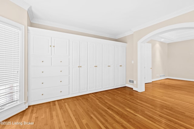 unfurnished bedroom with light wood-type flooring and ornamental molding